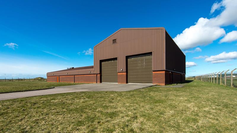 Front of building (security fencing visible)